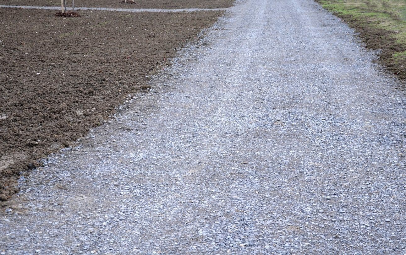 Newly installed gravel driveway leading up to a home